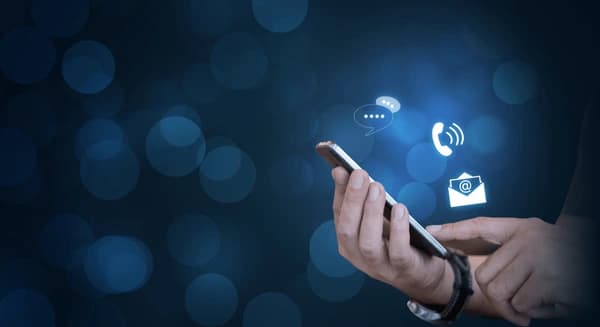 A person holding a smartphone, featuring icons for communication methods like calls, emails, and messages, highlighting accessibility and support.