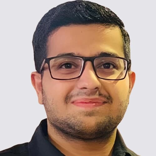 Headshot of Owais Tahir in glasses and a black shirt with a neutral background.